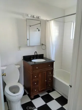 a bathroom with a sink toilet a mirror and shower