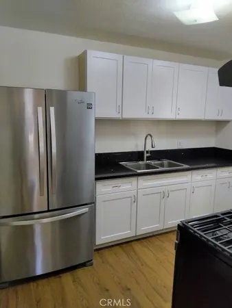 a kitchen with a refrigerator and cabinets
