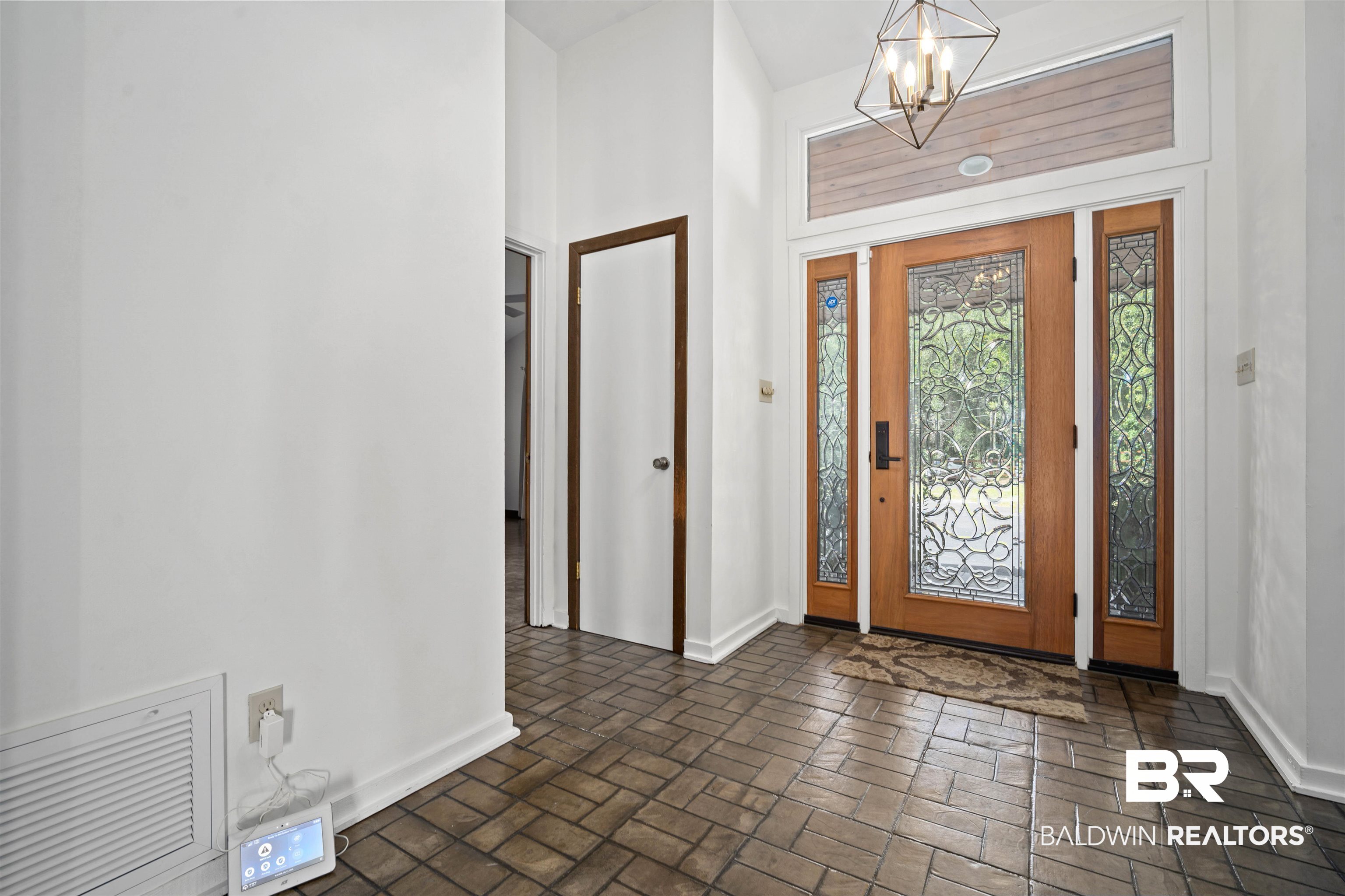 7912 Yorkhaven Road Mobile, AL 36695 - Photo 14 of 41 Foyer with brick flooring, a chandelier, and a towering ceiling