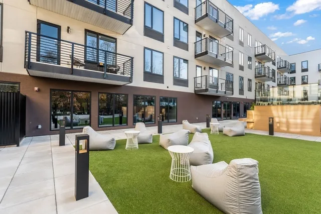 a view of a house with swimming pool and sitting area