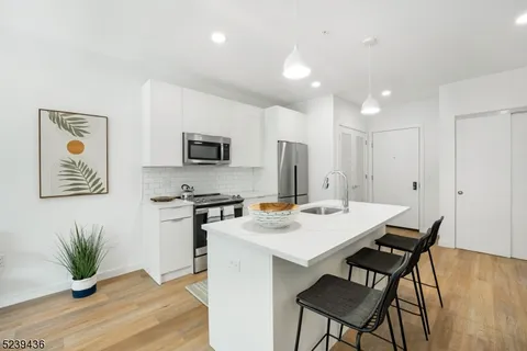 a view of kitchen with cabinets table and chairs