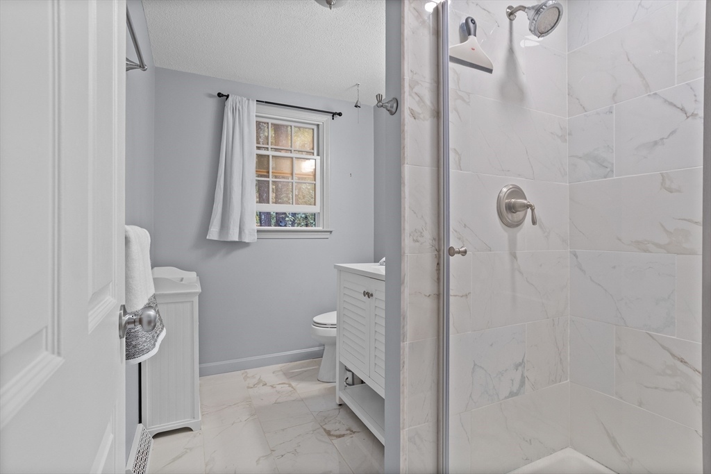35 Oxbow Lane Groton, MA 01450 - Photo 30 of 34 a bathroom with a granite countertop shower and a toilet