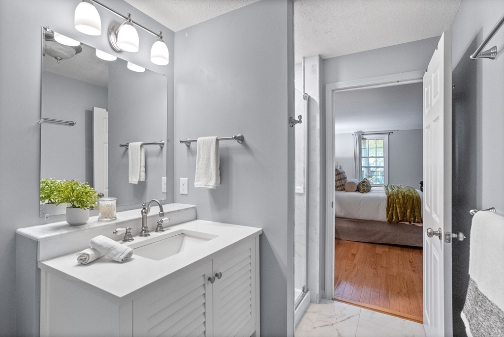 35 Oxbow Lane Groton, MA 01450 - Photo 31 of 34 a en suite bathroom with a sink double vanity and mirror