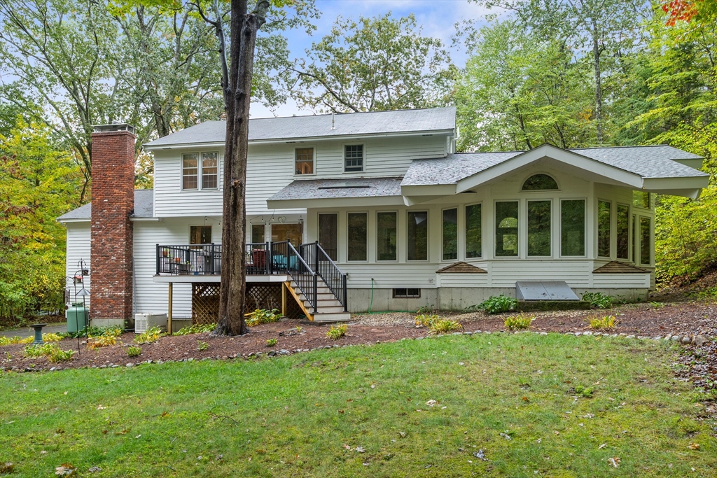35 Oxbow Lane Groton, MA 01450 - Photo 5 of 34 a front view of a house with a yard table and chairs
