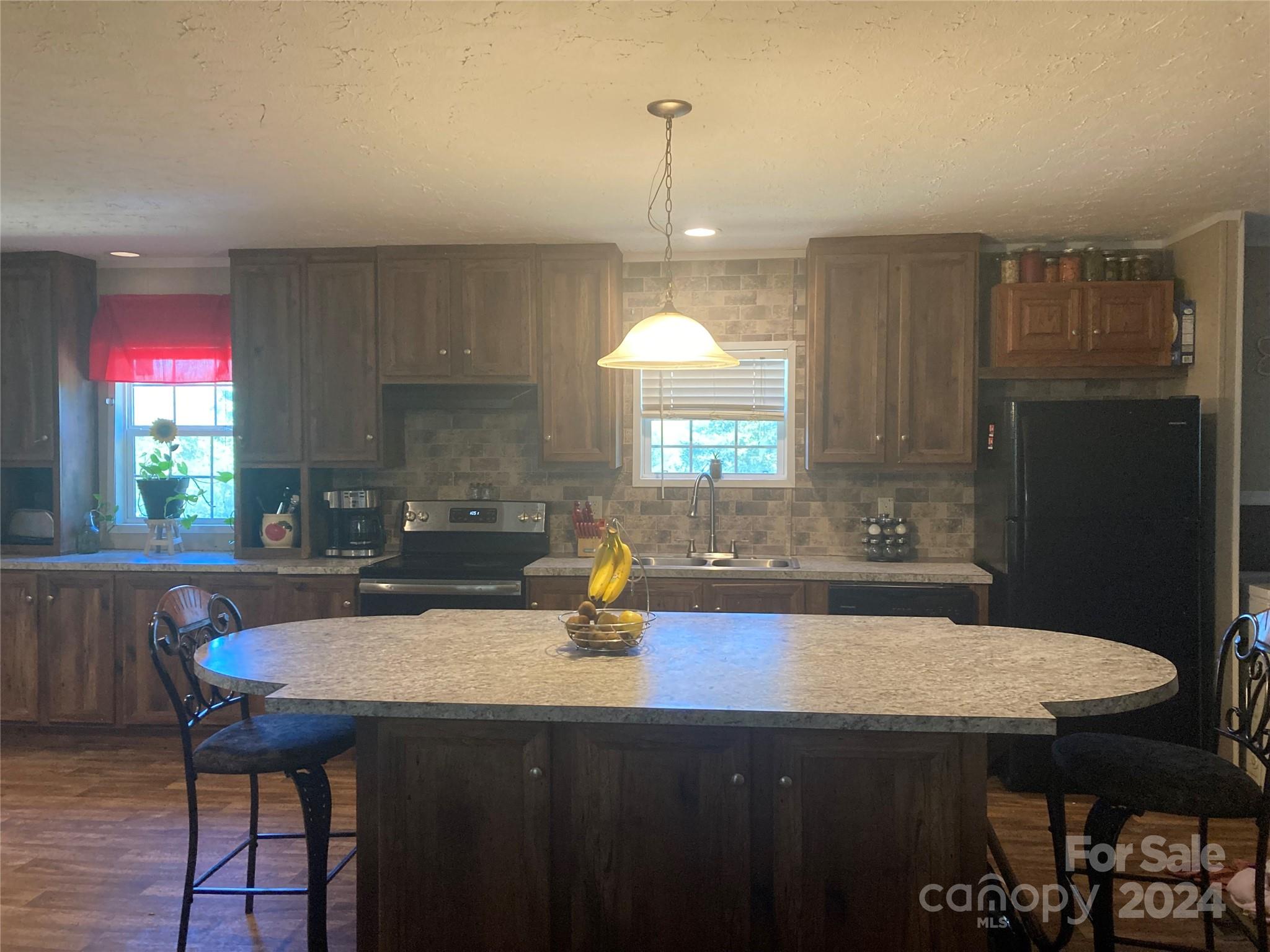 1739 Mary D Road, Unit 10 Chesterfield, SC 29709 - Photo 2 of 5 a kitchen with a table chairs sink and cabinets
