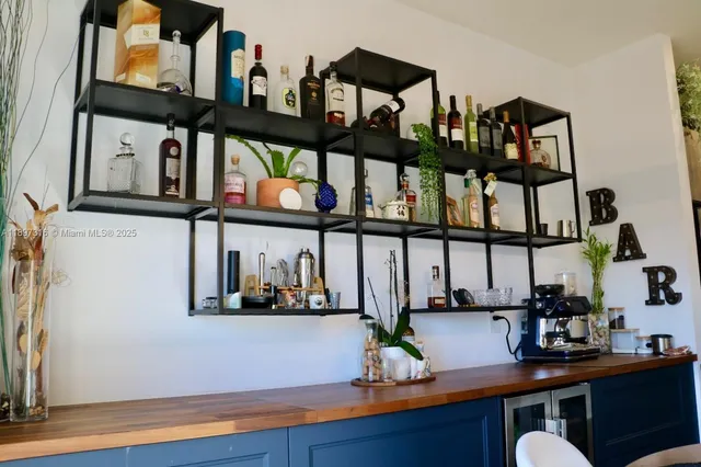 a table with wine bottles and glasses on it