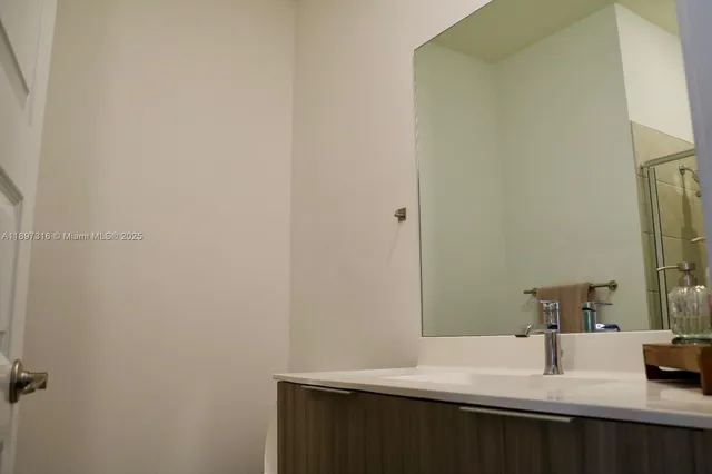 a bathroom with a sink and a mirror