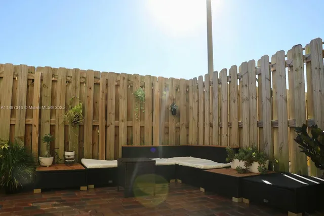 a view of a patio with a table and chairs