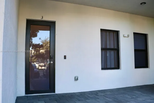 a view of a hallway with wooden floor and entryway