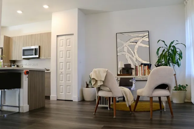 a view of a dining room with furniture and wooden floor