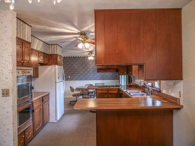 a kitchen with refrigerator and cabinets