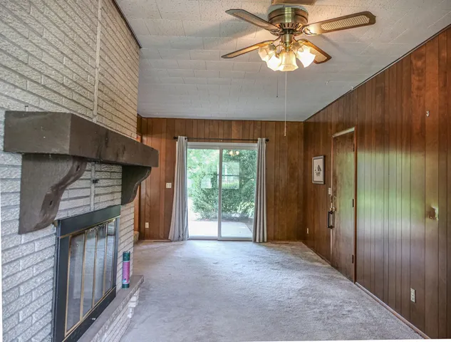 a view of empty room with window and ceiling fan