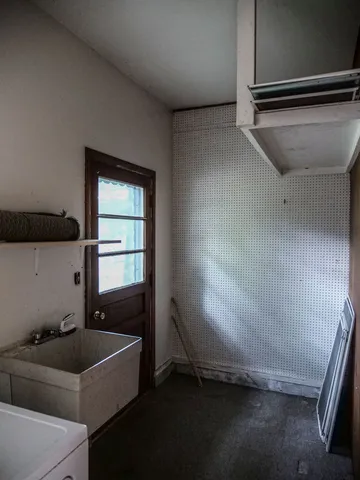 a backyard of a house with table and chairs