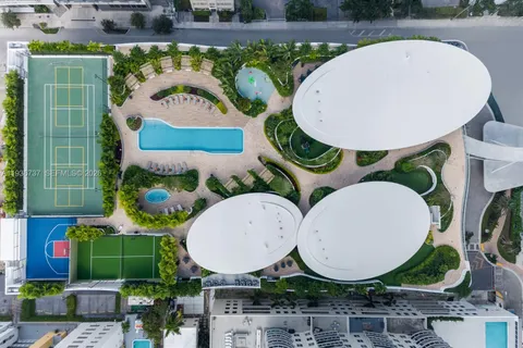 an aerial view of a backyard with swimming pool and outdoor seating