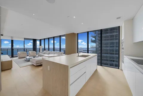 a large white kitchen with a large window