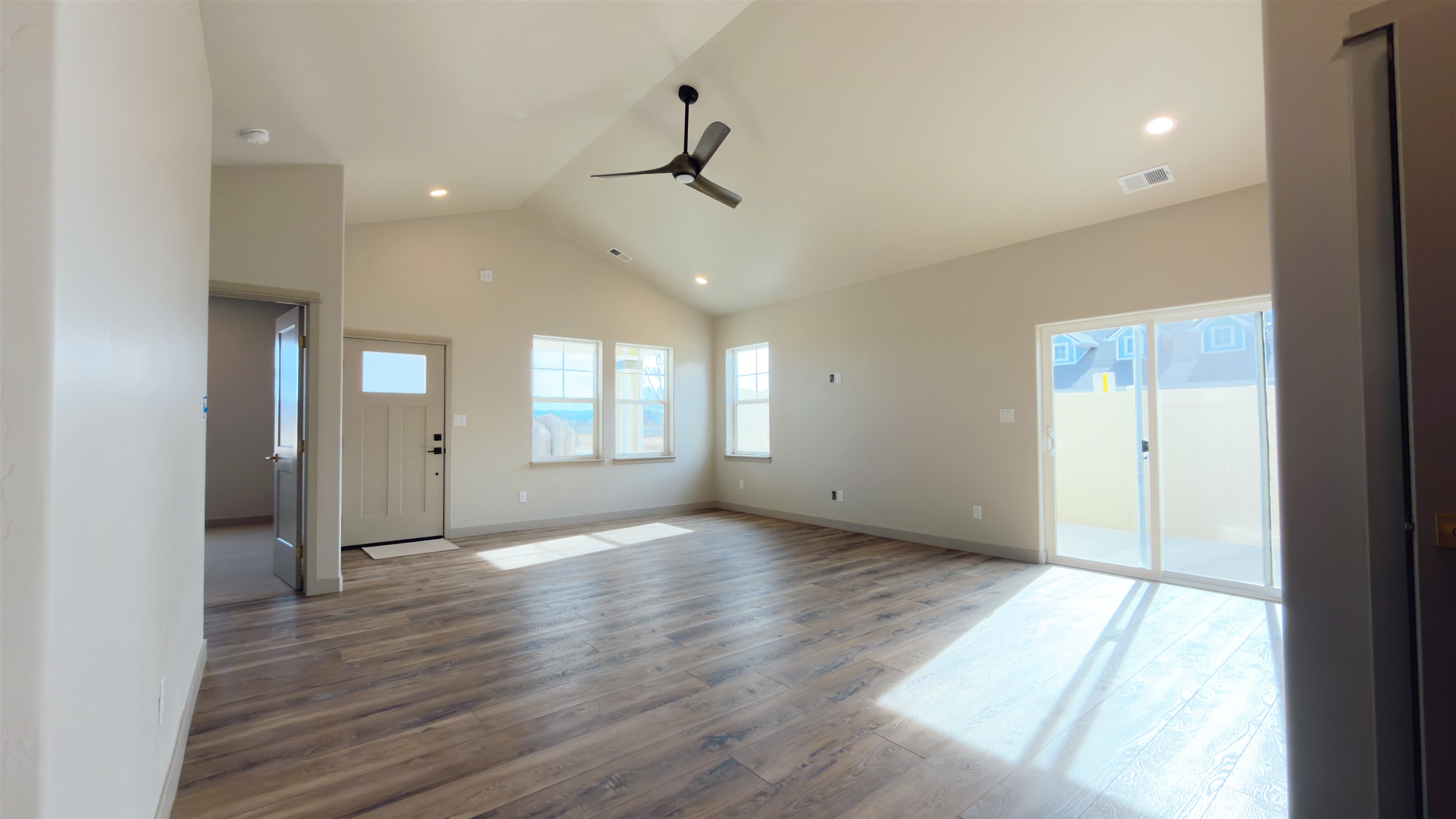 2003 Korima Drive Fruita, CO 81521 - Photo 4 of 19 an empty room with wooden floor and windows
