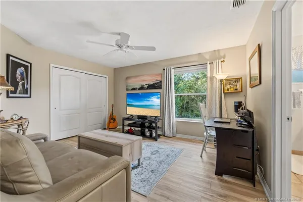 a living room with furniture and large windows