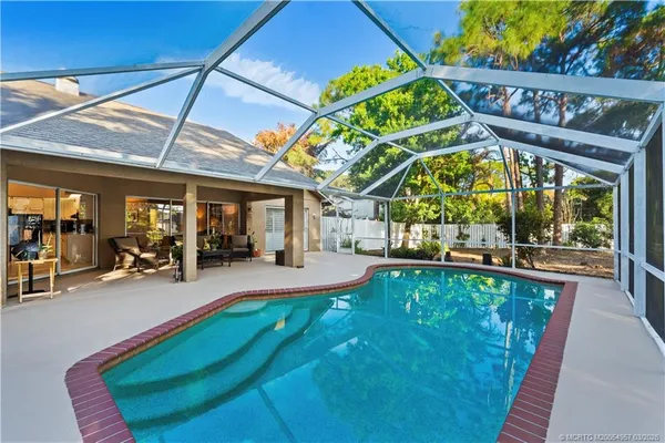 a view of a backyard patio and swimming pool