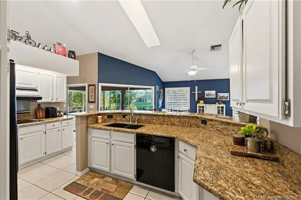 a kitchen with stainless steel appliances granite countertop a sink and cabinets