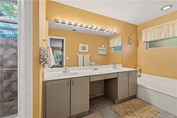 a bathroom with a double vanity sink and a mirror