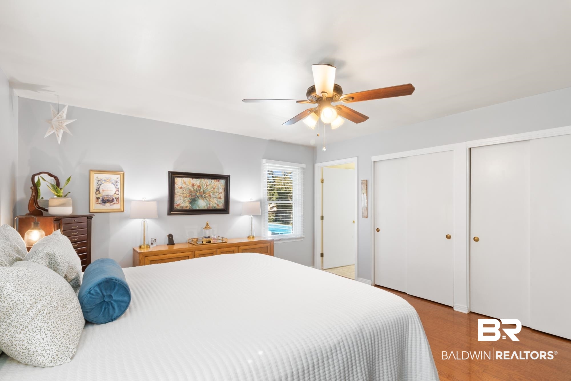 556 Stuart Street Daphne, AL 36526 - Photo 14 of 25 Bedroom featuring multiple closets, ceiling fan, and light wood-type flooring