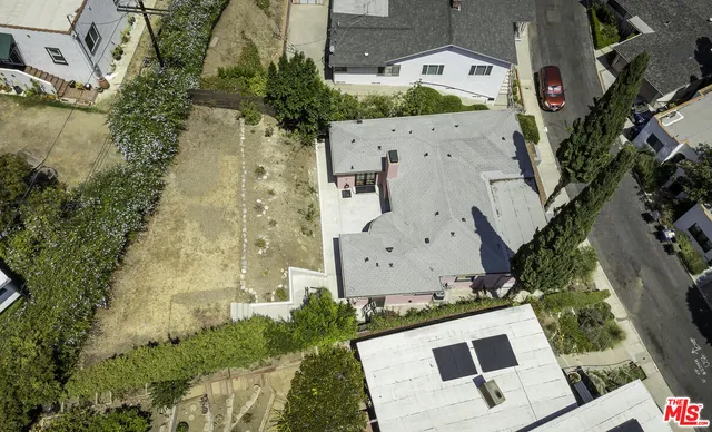 an aerial view of a house with a yard