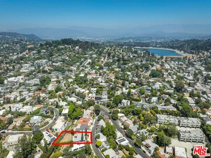 an aerial view of a residential houses with city view
