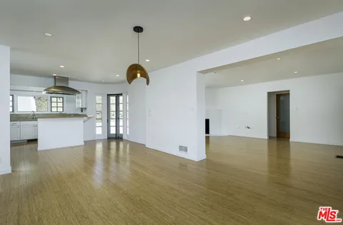 a kitchen with kitchen island a counter top space a sink and stainless steel appliances