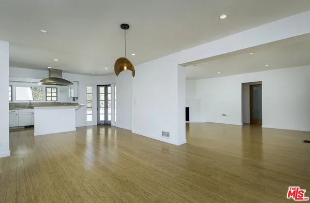 a kitchen with kitchen island a counter top space a sink and stainless steel appliances