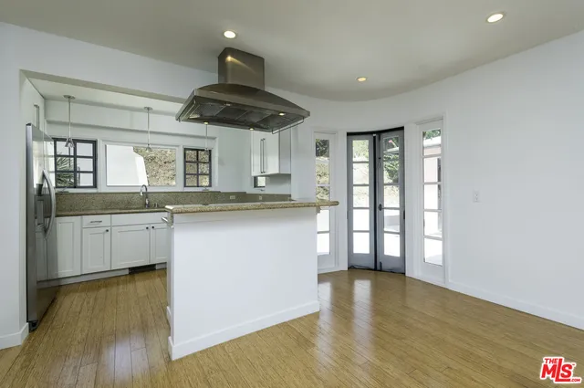 a kitchen with stainless steel appliances granite countertop a stove and a sink