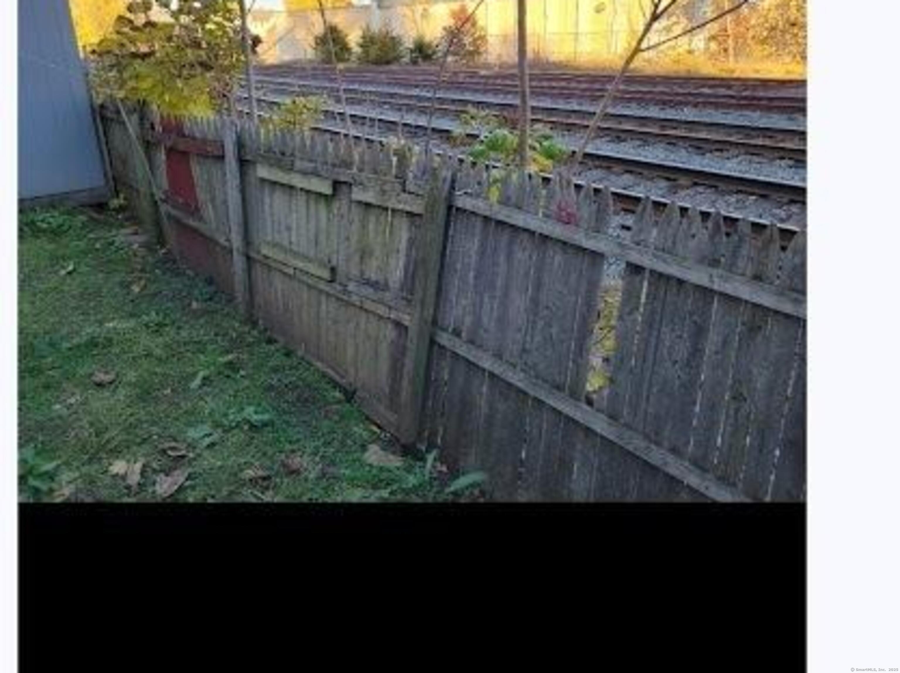 387 Colony Street Meriden, CT 06451 - Photo 3 of 8 a view of a wooden fence