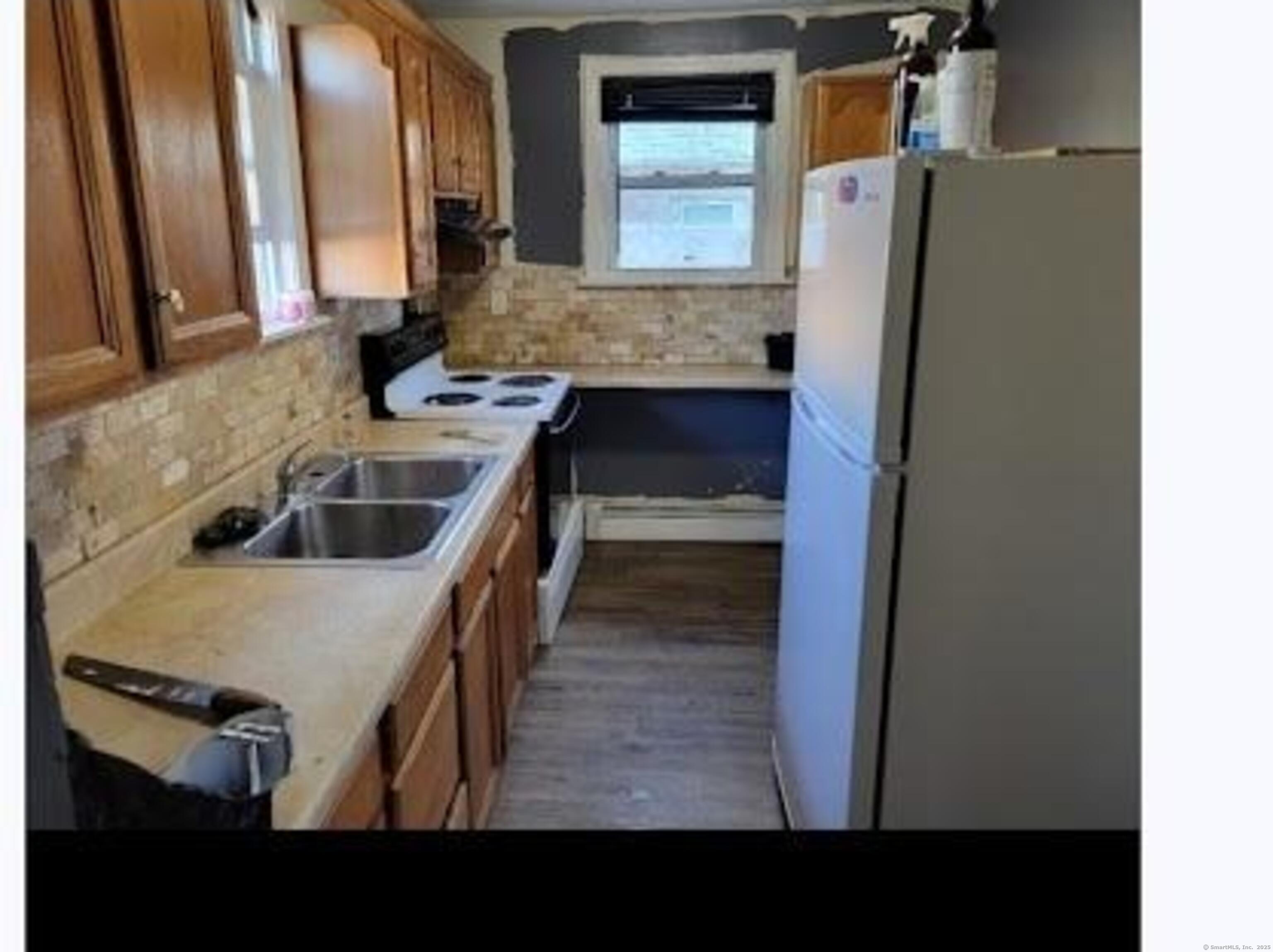 387 Colony Street Meriden, CT 06451 - Photo 6 of 8 a kitchen with stainless steel appliances granite countertop a sink and a refrigerator