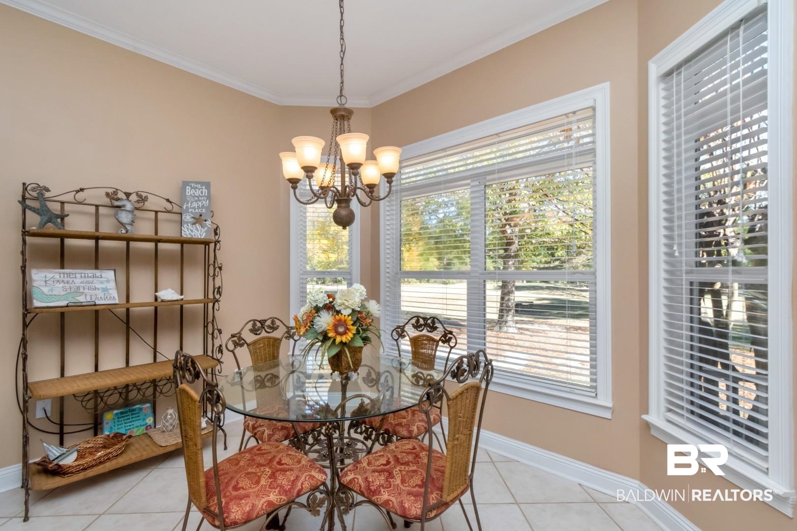 9905 Carnoustie Court Foley, AL 36535 - Photo 11 of 31 Dining area featuring light tile patterned flooring, a chandelier, and crown molding