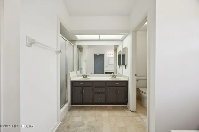 a bathroom with a double vanity sink mirror and double