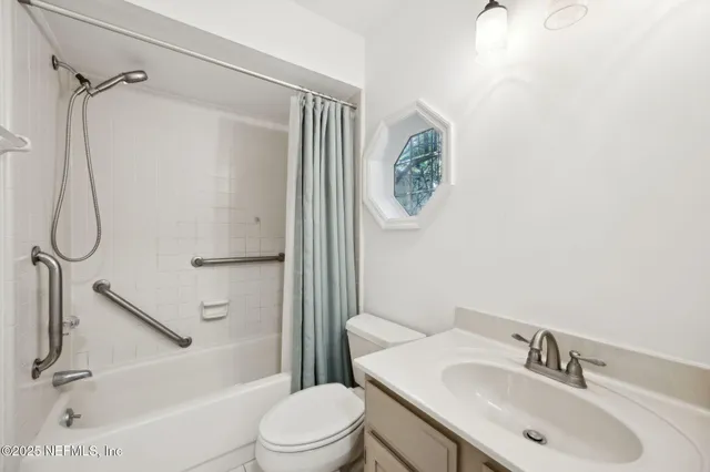 an empty room with a window and ceiling fan