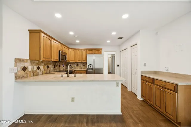 a kitchen with a sink stove and microwave