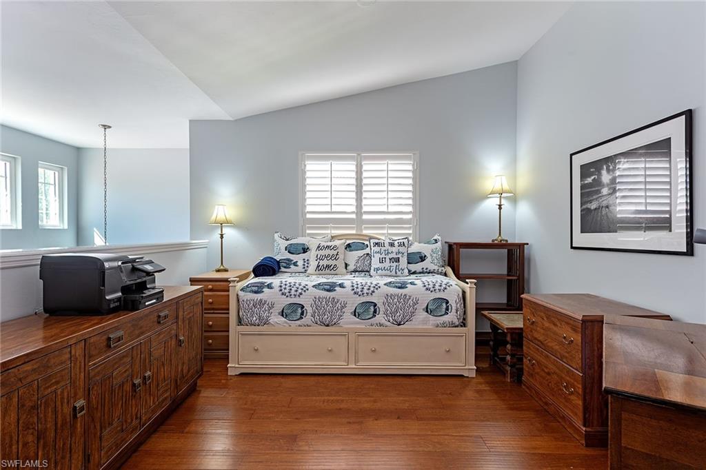 2540 Talon Court, Unit 503 Naples, FL 34105 - Photo 12 of 14 a spacious bedroom with a bed and wooden floor