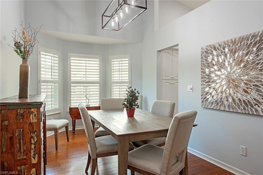 2540 Talon Court, Unit 503 Naples, FL 34105 - Photo 3 of 14 a view of a dining room with furniture window and wooden floor