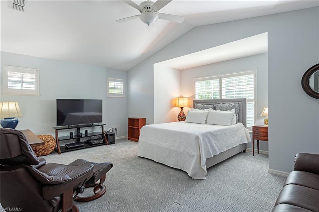 2540 Talon Court, Unit 503 Naples, FL 34105 - Photo 8 of 14 a bedroom with a bed and a flat screen tv