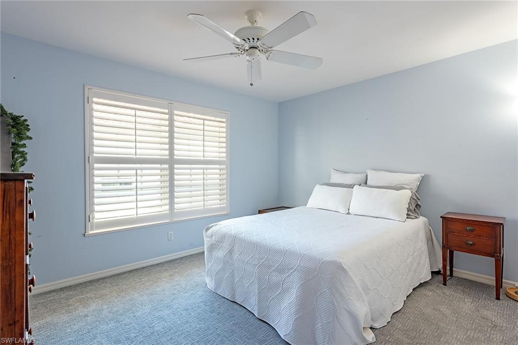 2540 Talon Court, Unit 503 Naples, FL 34105 - Photo 10 of 14 a large bed sitting in a bedroom next to a window