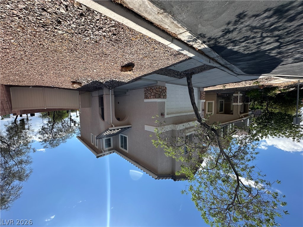 7305 Prussian Green Street Las Vegas, NV 89139 - Photo 2 of 23 A desert-friendly front yard and practical driveway create appealing curb appeal.
