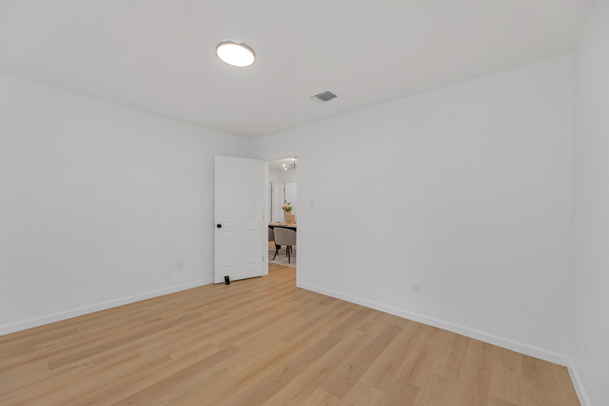 1709 Cecelia Street Taylor, TX 76574 - Photo 25 of 37 Empty room featuring light wood finished floors and baseboards