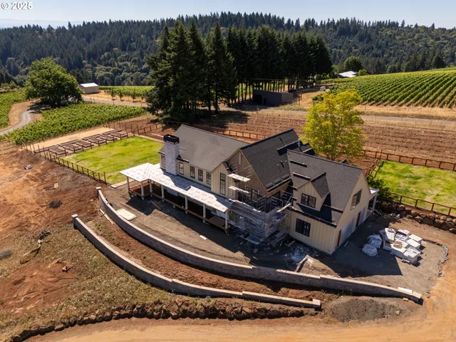 a view of a swimming pool with a bench and trees in the background