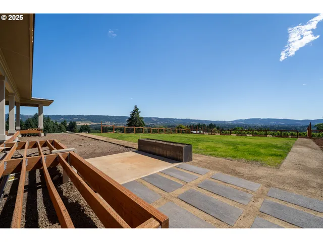 a view of swimming pool with seating area and yard