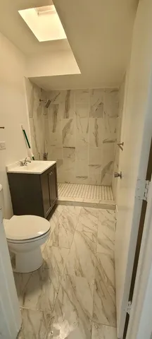 a bathroom with a sink toilet and shower
