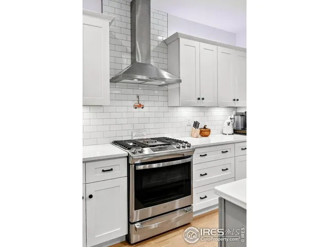 a kitchen with kitchen island a sink stove and cabinets
