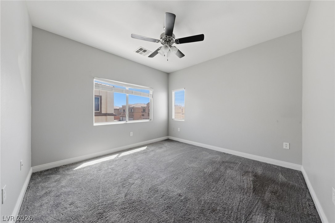 6312 Sandy Ridge Street, Unit 3102 North Las Vegas, NV 89081 - Photo 16 of 31 A well-lit room featuring ample natural light and plush carpeting.