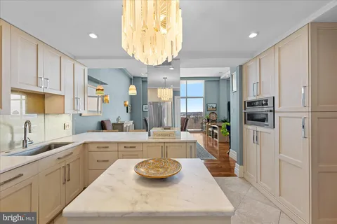 a view of a hallway with wooden floor and a bathroom