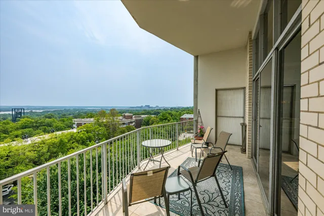 a large space with stainless steel appliances kitchen island granite countertop a refrigerator and a sink