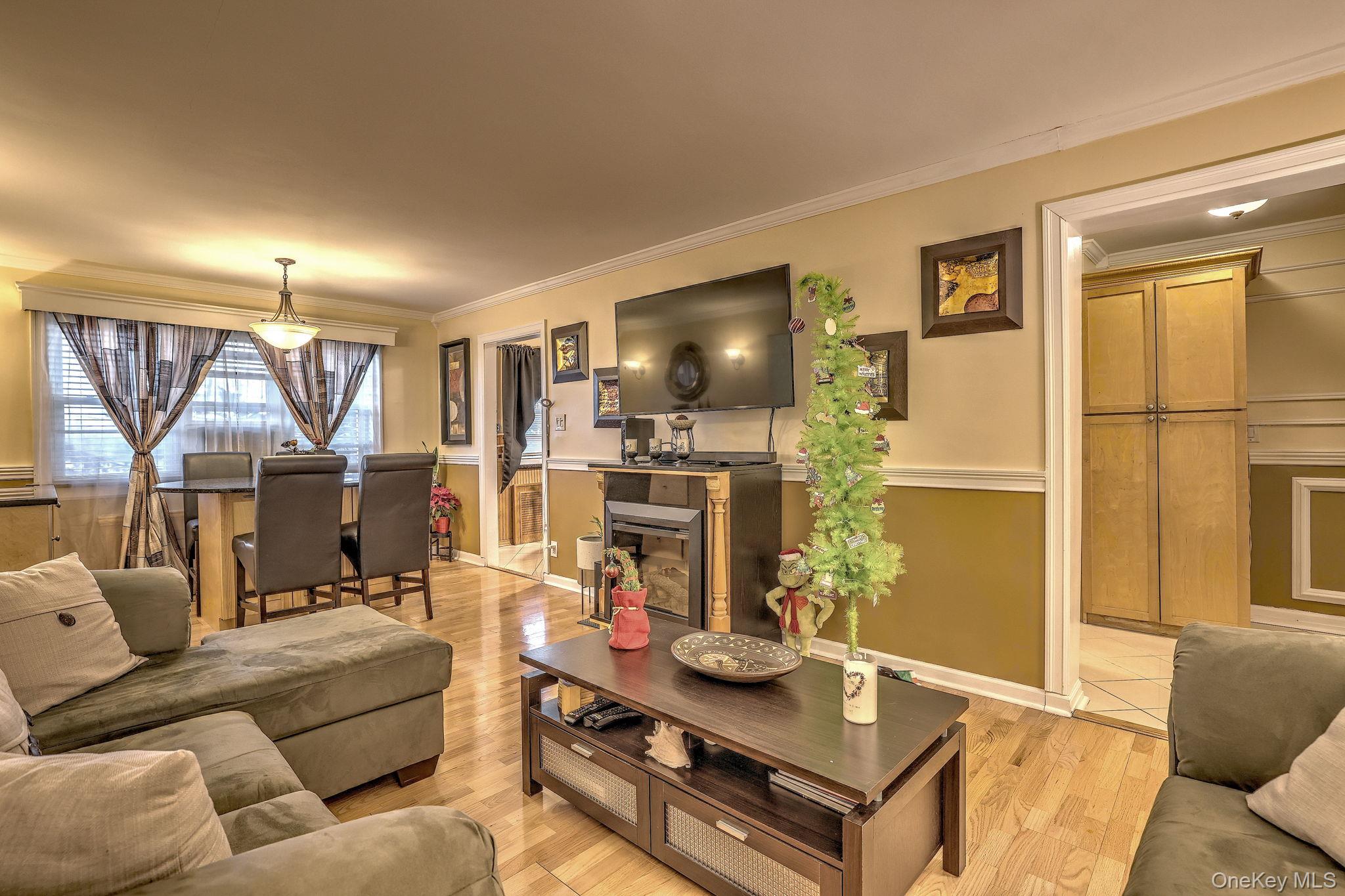 450 Pelham Road, Unit 3B New Rochelle, NY 10805 - Photo 11 of 19 a living room with furniture and a flat screen tv